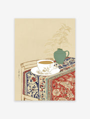 Still life wall art illustration of a tea cup, green vase with plant, and patterned red and blue textile on a table.