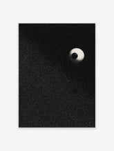 Stippled eyeball art print with a black pupil and light sclera on a speckled black background, portrait orientation