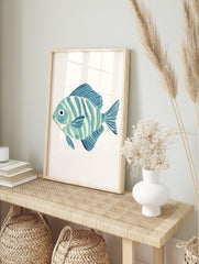 Blue and white striped fish watercolour illustration art print on a plain white background, in an alternate framed mockup