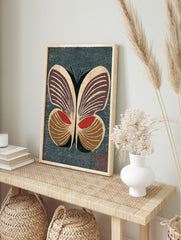 Stylised butterfly woodblock print with deep purple, red, and brown wings on a textured dark, in an alternate framed mockup