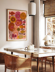 Stylised orange and yellow striped fish with abstract red and orange floral shapes on a pink, in a styled room mockup