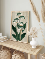 Stylised green plant botanical illustration with patterned caps and leaves on a light beige, in an alternate framed mockup