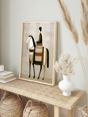 Stylised abstract art print of a rider on a horse in earth tones, black, and white, in an alternate framed mockup