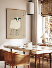 Minimalist illustrative sheep art print with black and white details on a beige background, in a styled room mockup