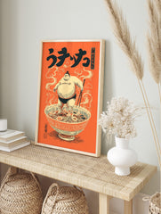 Japanese illustrative print of a sumo wrestler standing in a large ramen bowl with, in an alternate framed mockup