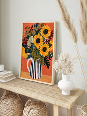 Sunflower bouquet in a black and white striped pitcher on an orange background, illustrative, in an alternate framed mockup