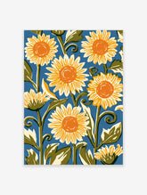 Sunflower wall art print with yellow petals, orange centres, and green stems on a blue background