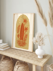 Tropical surfboard and palm tree illustration print in terracotta and beige with sun motif, in an alternate framed mockup