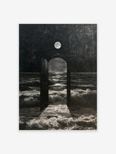 Surreal wall art of an open door on a beach facing a dark, stormy ocean under a full moon