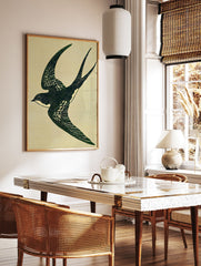 Illustrative art print of a dark green swallow bird in flight with white speckles against a light beige textured background. - Image 2