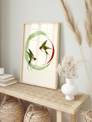 Swallow wall art print with two birds in flight inside a green ink wash circle and red arc on, in an alternate framed mockup