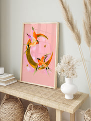 Abstract swallow bird illustration flying around a golden crescent moon on a pink background, in an alternate framed mockup