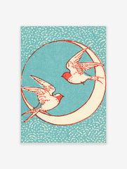 Vintage-style illustrative print of two swallows flying around a crescent moon against a speckled blue background