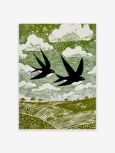Stylised linocut print of two black swallows flying over green fields and white clouds in a green sky