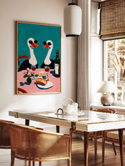 Painterly wall art of two swans in sunglasses at a pink dining table with wine, cheese, and flowers, in a styled room mockup