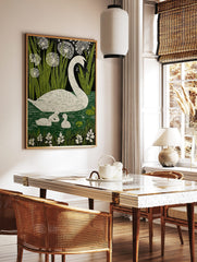 White swan and two cygnets swimming in green water with reeds and white flowers against a dark, in a styled room mockup