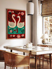 Folk art painting of two white swans forming a heart, red wine bottle, glass, and pink flowers on, in a styled room mockup