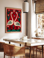 Illustrative print of two white swans forming a heart, with a wine glass, pink and blue flowers on, in a styled room mockup