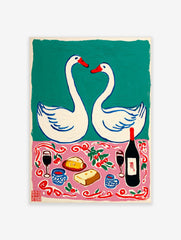 Illustrative wall art with two white swans and a romantic picnic scene with wine, cheese, and bread on a pink cloth