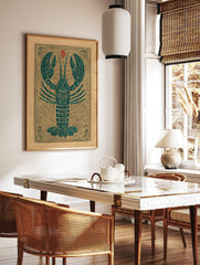 Teal lobster woodcut style art print on a tan background with red symbol and decorative border, in a styled room mockup