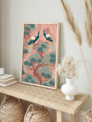 Two teal peacocks on a pine tree with fan-like leaves against a pink background, oriental, in an alternate framed mockup