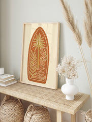 Illustrative palm tree and leafy plants in olive green with white outlines, on a terracotta, in an alternate framed mockup