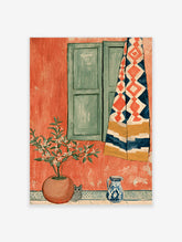 Terracotta wall art print with green shutters, patterned curtain, potted citrus tree, grey cat, and blue jug