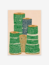 Illustrative textile spool wall art print showing stacks of green, blue, and brown spools on a light background.