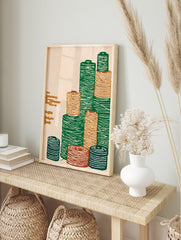 Illustrative textile spool wall art print showing stacked green, orange, and blue thread bobbins on a cream background - Image 3