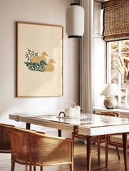 Illustrative print of three ducks, one floral teal, two golden yellow, with green leaves and yellow, in a styled room mockup