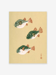 Three pufferfish in Japanese woodblock style with green bodies and orange fins on a cream background