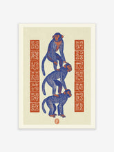 Blue three wise monkeys poster with orange faces stacked vertically beside red seal blocks on cream paper
