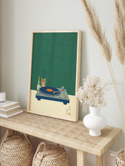 Tiger head, green sake bottle, and blue turntable with orange record on speckled green, in an alternate framed mockup