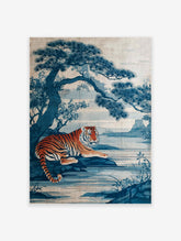 Japanese indigo art poster featuring an orange and black striped tiger lying by a blue lake with a large pine tree.
