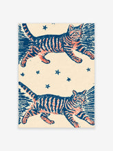 Orange and blue striped cats leaping among stars on cream background art print