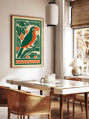 Illustrative toucan bird print with orange beak, green body, tropical leaves, and orange flowers on, in a styled room mockup