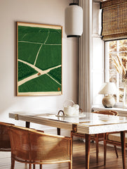 Orange tractor driving on a crossroad in a vast green field, illustrative minimalist wall art print, in a styled room mockup