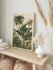 Illustrative jungle scene with tropical birds, palm trees, and large green leaves on a, in an alternate framed mockup