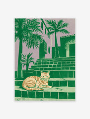 Tropical cat print of a striped feline resting on steps with palm trees and a building against a purple sky.