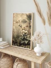 Botanical art print of a tropical garden with palm trees, tall grasses, and flowering plants, in an alternate framed mockup