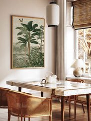 Lush tropical jungle wall art with large green banana leaves, tall trees, exotic birds, a river, and distant misty mountains. - Image 2