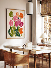 Vibrant tulip flower botanical art print with pink and orange petals and green leaves on a light, in a styled room mockup