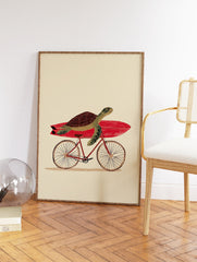 Illustrated green turtle with a brown shell carrying a red surfboard on a bicycle, against a cream background. Whimsical wall art. - Image 2