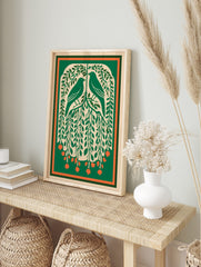 Illustrative green art print of two birds in a leafy tree with orange berries and a, in an alternate framed mockup