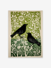 Two black birds with white eyes in a green and white botanical linocut art print, portrait orientation