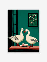 Two white geese with red beaks facing each other over cake slices on a table, against a teal green wall