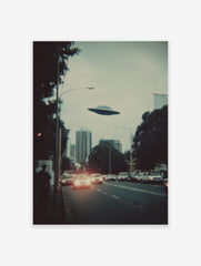Retro sci-fi print of a UFO flying over a city skyline with cars and buildings at dusk