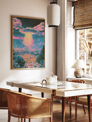 Psychedelic UFO desert landscape wall art print with vibrant pink and teal colours and a glowing, in a styled room mockup