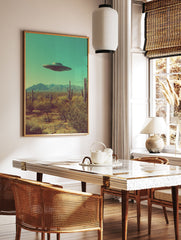 Retro UFO wall art print featuring a flying saucer hovering over a desert landscape with cacti and mountains under a teal sky. - Image 3