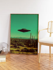 UFO flying saucer hovering over a desert landscape with saguaro cacti under a teal sky, retro sci-fi art print. - Image 2